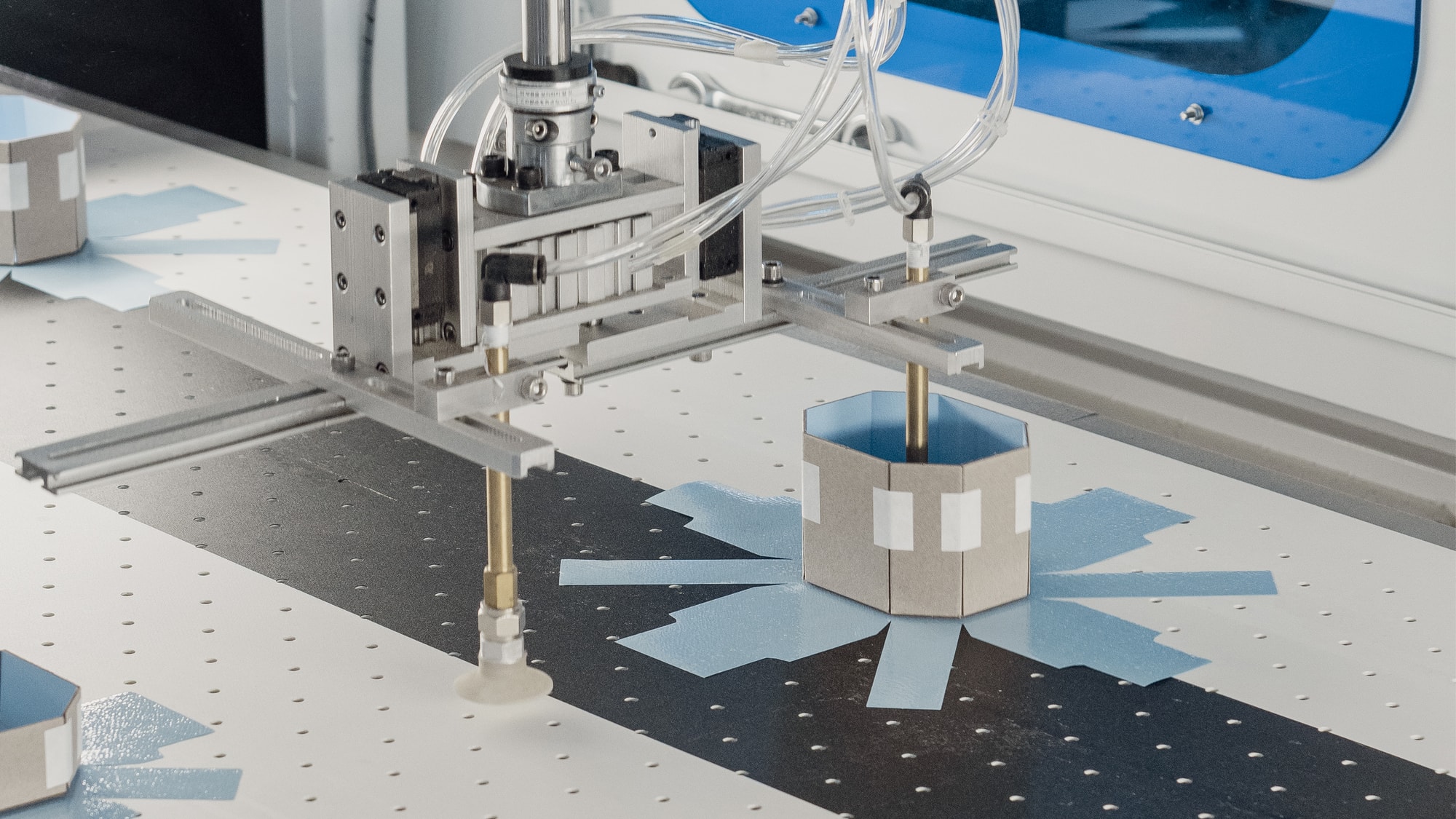 A die cutter forming a rigid box from printed board
