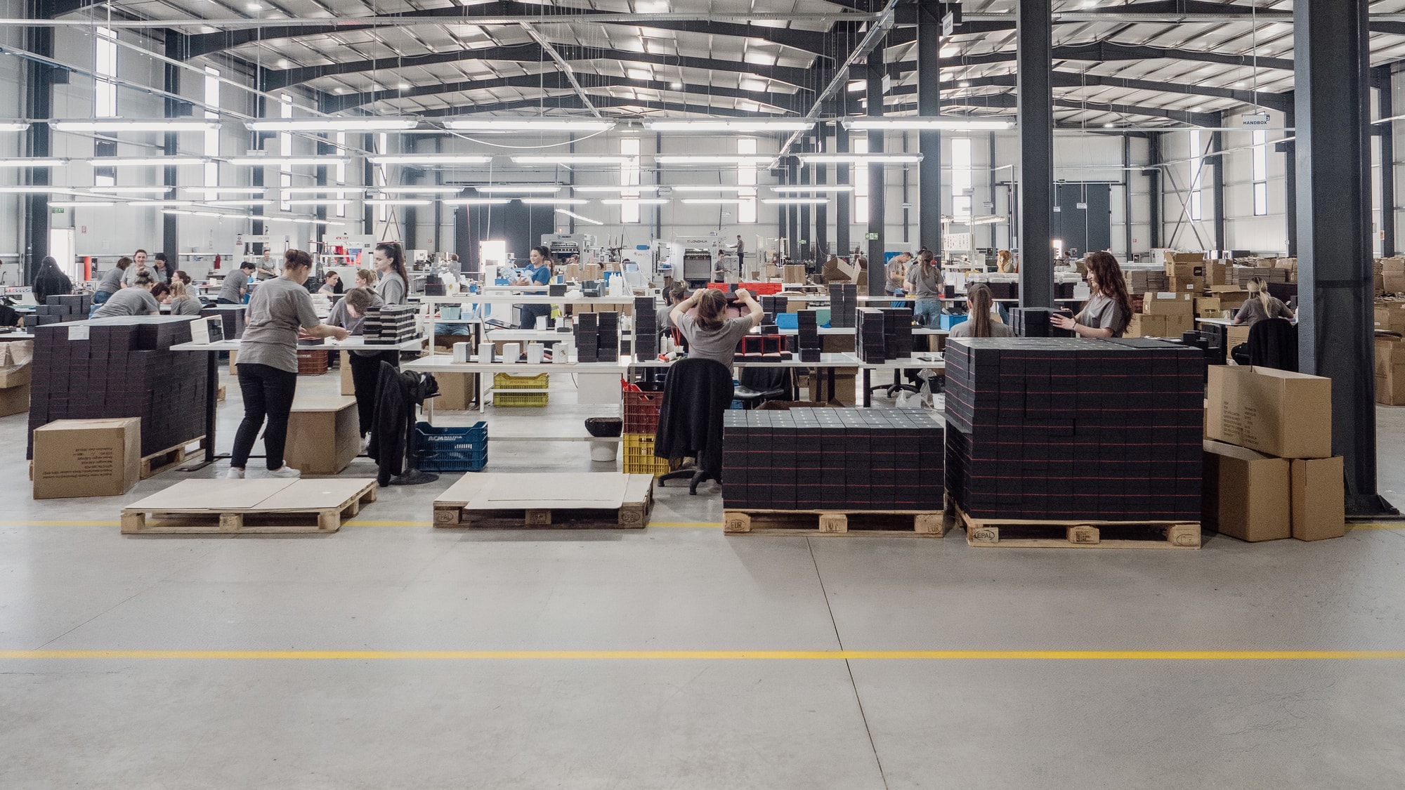 Production floor with staff assembling packaging