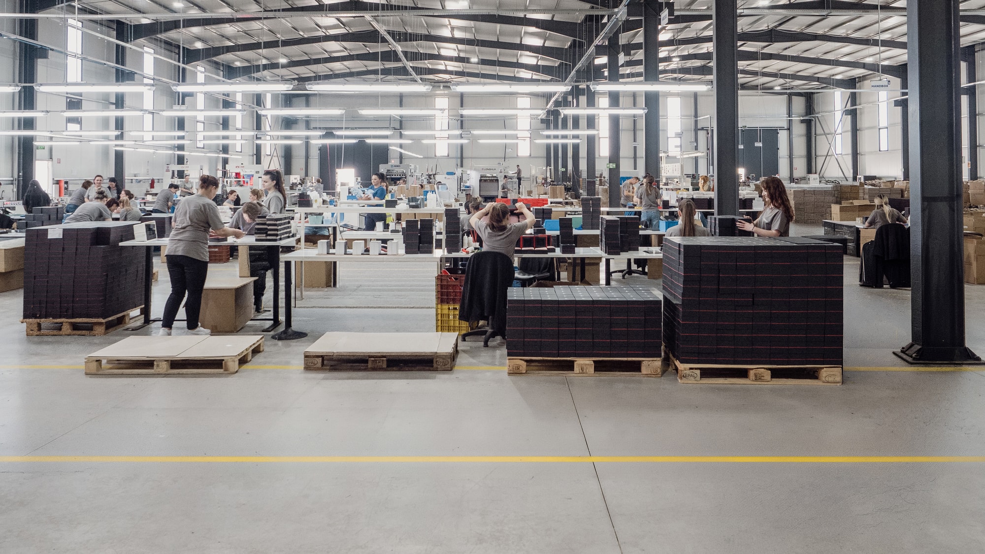 Production floor with staff assembling packaging